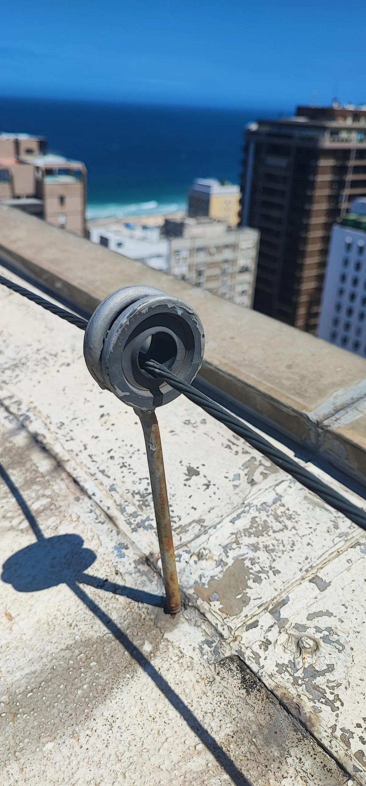 Conexão do cabo de descida ao suporte isolador fixado na platibanda da cobertura.